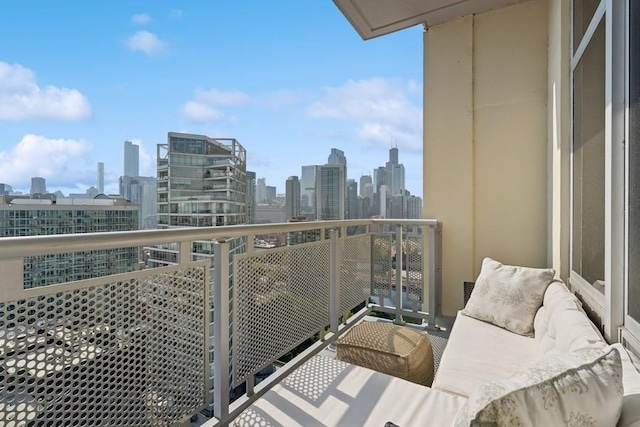balcony featuring a skyline view and outdoor lounge area