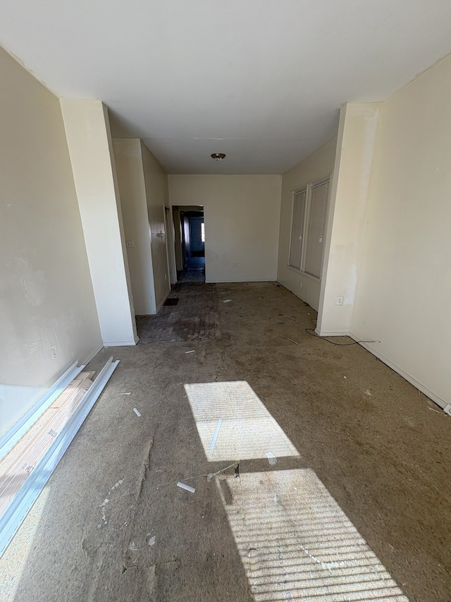 spare room with baseboards