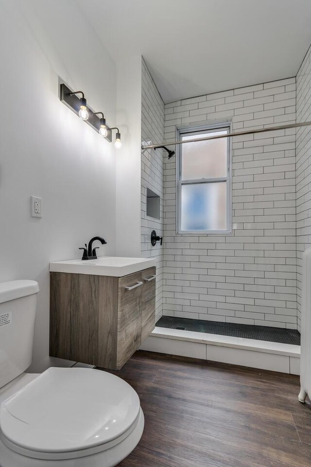 1922 Harvey Ave, Berwyn, IL 60402 - full bathroom featuring vanity, a shower stall, toilet, and wood finished floors