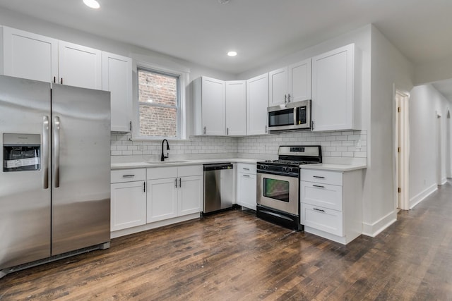 1922 Harvey Ave, Berwyn, IL 60402 - kitchen featuring stainless steel appliances, a sink, light countertops, dark wood-style floors, and tasteful backsplash