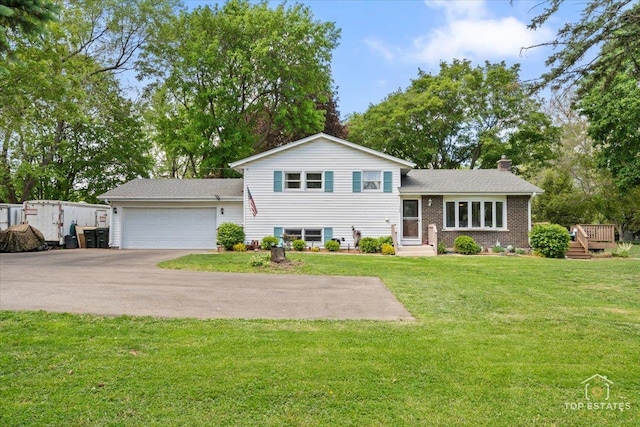 120 3 Oaks Rd, Cary, IL 60013 - split level home featuring a chimney, asphalt driveway, a garage, a front yard, and brick siding