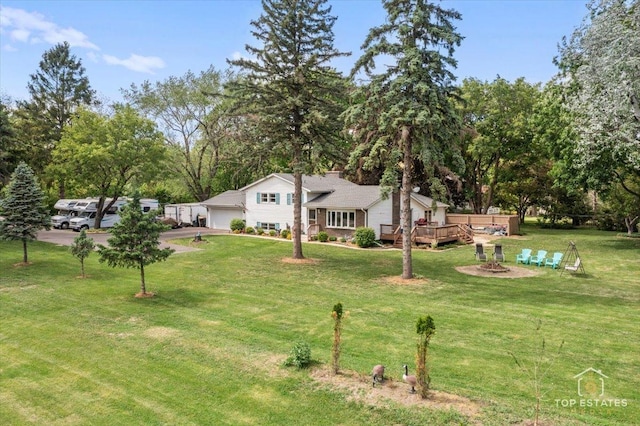 120 3 Oaks Rd, Cary, IL 60013 - view of green lawn featuring an attached garage, a deck, and driveway