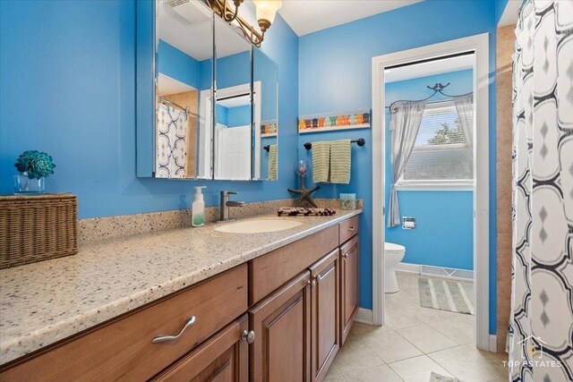 120 3 Oaks Rd, Cary, IL 60013 - full bathroom with vanity, toilet, tile patterned floors, and baseboards