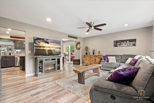 120 3 Oaks Rd, Cary, IL 60013 - living area featuring a ceiling fan, light wood-style flooring, recessed lighting, and a glass covered fireplace