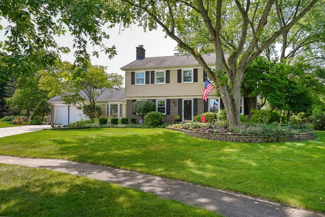 25W651 Towpath Ct, Wheaton, IL 60189 - colonial inspired home with a chimney, brick siding, a front yard, a garage, and concrete driveway
