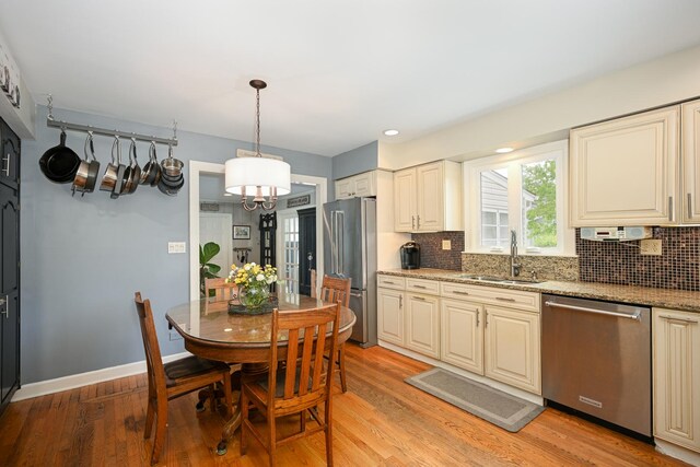 25W651 Towpath Ct, Wheaton, IL 60189 - kitchen featuring stainless steel appliances, a sink, a chandelier, decorative backsplash, and recessed lighting