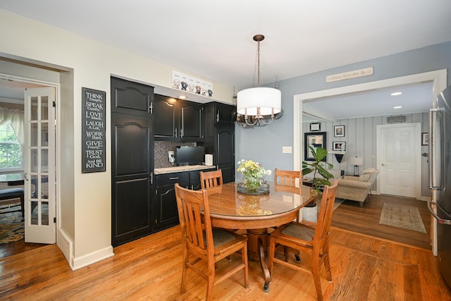 25W651 Towpath Ct, Wheaton, IL 60189 - dining space with light wood-style flooring, a chandelier, and baseboards