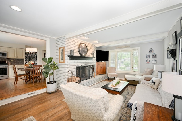25W651 Towpath Ct, Wheaton, IL 60189 - living area with light wood-style floors, a fireplace, and crown molding