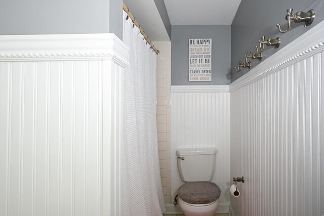 25W651 Towpath Ct, Wheaton, IL 60189 - bathroom with toilet, a shower with curtain, and a wainscoted wall