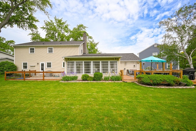 25W651 Towpath Ct, Wheaton, IL 60189 - back of property with a chimney, a deck, a sunroom, and a yard