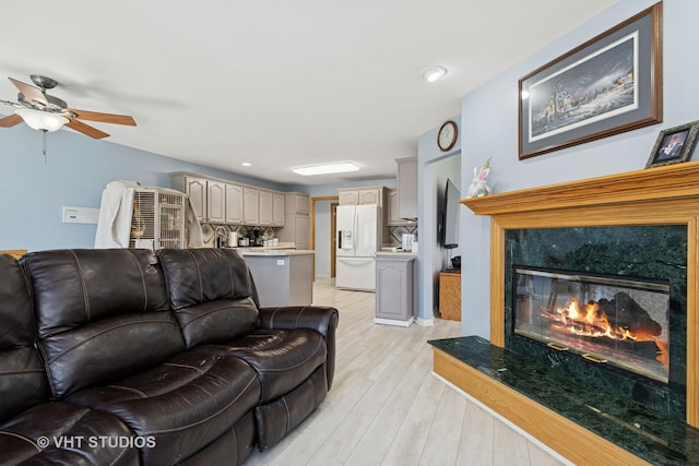 6719 W Applewood Ln, Spring Grove, IL 60081 - living room with light wood finished floors, ceiling fan, and a premium fireplace