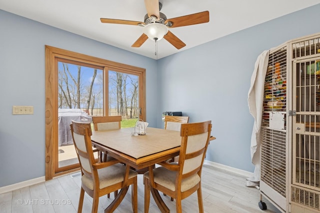 6719 W Applewood Ln, Spring Grove, IL 60081 - dining area featuring light wood-style floors, a ceiling fan, and baseboards