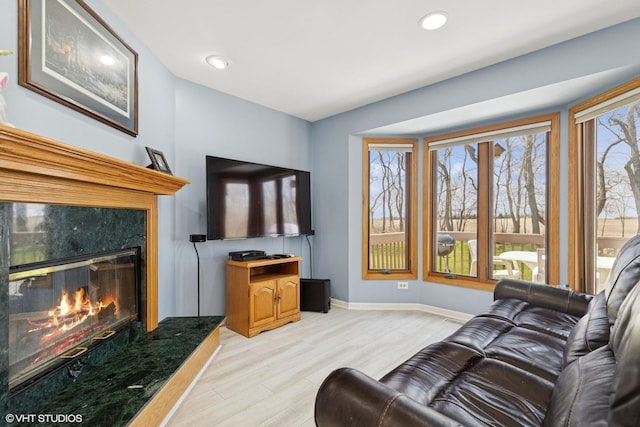 6719 W Applewood Ln, Spring Grove, IL 60081 - living room featuring baseboards, light wood-style floors, a premium fireplace, and recessed lighting