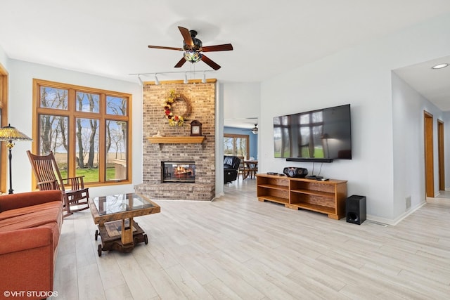 6719 W Applewood Ln, Spring Grove, IL 60081 - living area featuring a ceiling fan, a fireplace, wood finished floors, and baseboards