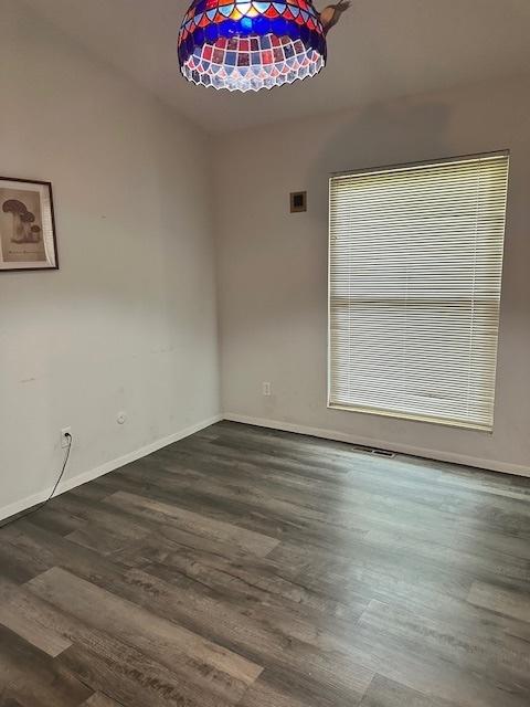 2302 Melrose Dr Unit A, Champaign, IL 61820 - empty room featuring dark wood-style floors and baseboards