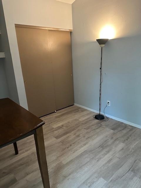 2302 Melrose Dr Unit A, Champaign, IL 61820 - unfurnished bedroom featuring wood finished floors and baseboards