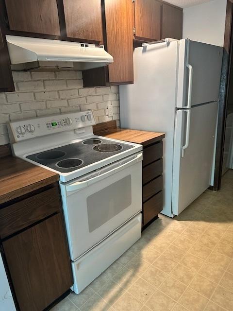 2302 Melrose Dr Unit A, Champaign, IL 61820 - kitchen with white appliances, under cabinet range hood, and light countertops