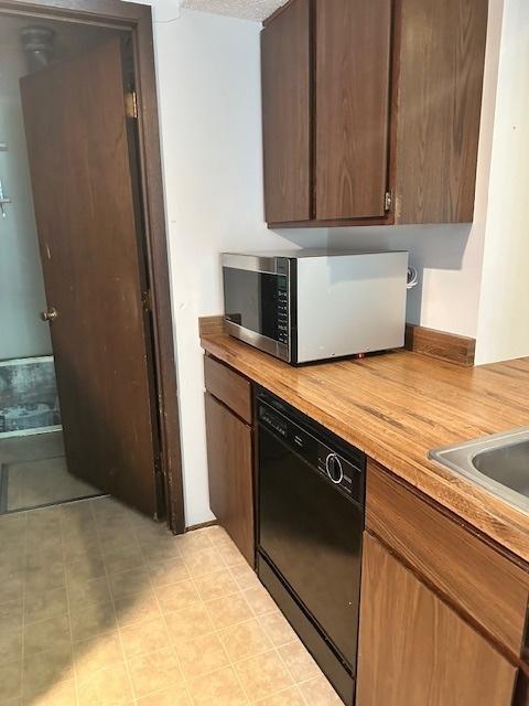 2302 Melrose Dr Unit A, Champaign, IL 61820 - kitchen featuring stainless steel microwave, dishwasher, and butcher block countertops