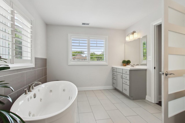 16829 Sheridans Trl, Orland Park, IL 60467 - bathroom featuring a whirlpool tub, vanity, tile patterned flooring, and tile walls