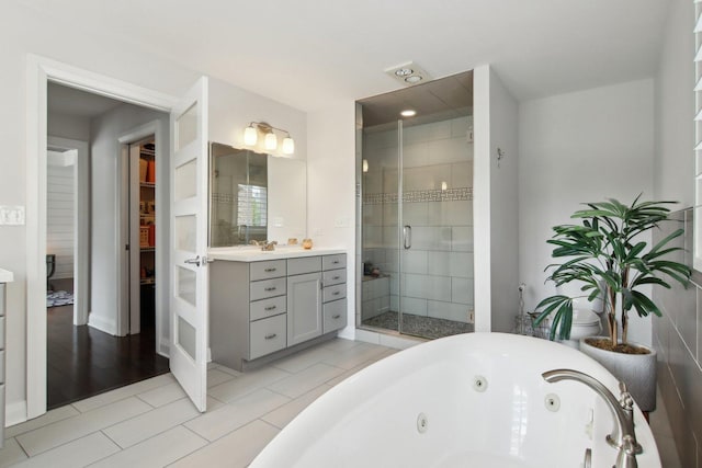 16829 Sheridans Trl, Orland Park, IL 60467 - bathroom featuring vanity, a shower stall, a jetted tub, and tile patterned floors
