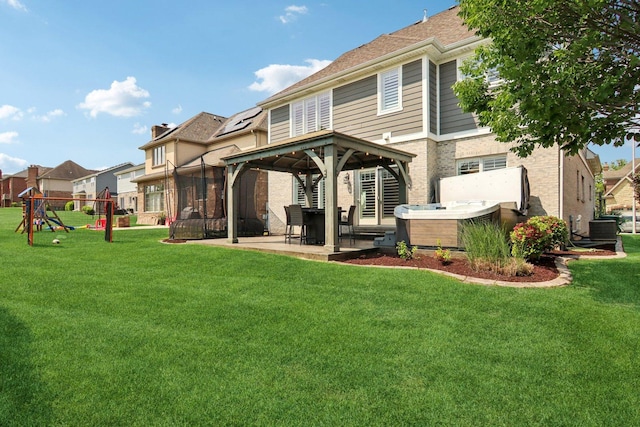 16829 Sheridans Trl, Orland Park, IL 60467 - back of house featuring a gazebo, a hot tub, a playground, a patio area, and a yard