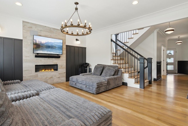 16829 Sheridans Trl, Orland Park, IL 60467 - living area featuring stairway, ornamental molding, wood finished floors, a chandelier, and a fireplace