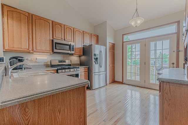 11656 Lake Shore Dr, Orland Park, IL 60467 - kitchen with stainless steel appliances, vaulted ceiling, light wood-style flooring, hanging light fixtures, and light countertops