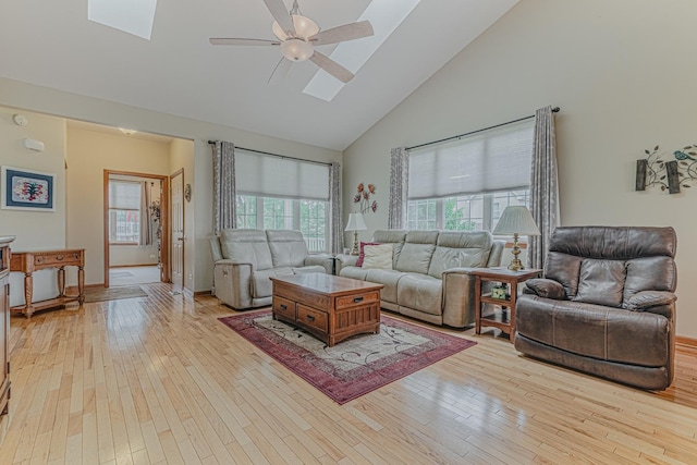 11656 Lake Shore Dr, Orland Park, IL 60467 - living area with high vaulted ceiling, a skylight, a ceiling fan, and light wood-style floors