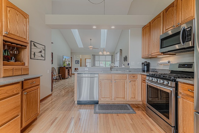 11656 Lake Shore Dr, Orland Park, IL 60467 - kitchen featuring stainless steel appliances, lofted ceiling, a peninsula, light wood finished floors, and ceiling fan