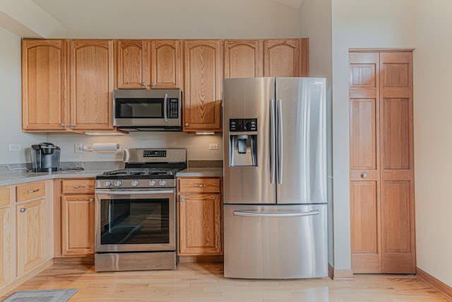 11656 Lake Shore Dr, Orland Park, IL 60467 - kitchen featuring stainless steel appliances, light wood-style floors, and vaulted ceiling