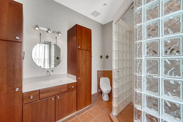 1044 S E Ave, Oak Park, IL 60304 - full bathroom featuring tile walls, a shower stall, tile patterned floors, vanity, and toilet
