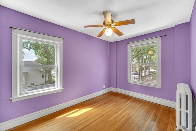 1044 S E Ave, Oak Park, IL 60304 - unfurnished room with radiator, baseboards, wood-type flooring, and a ceiling fan