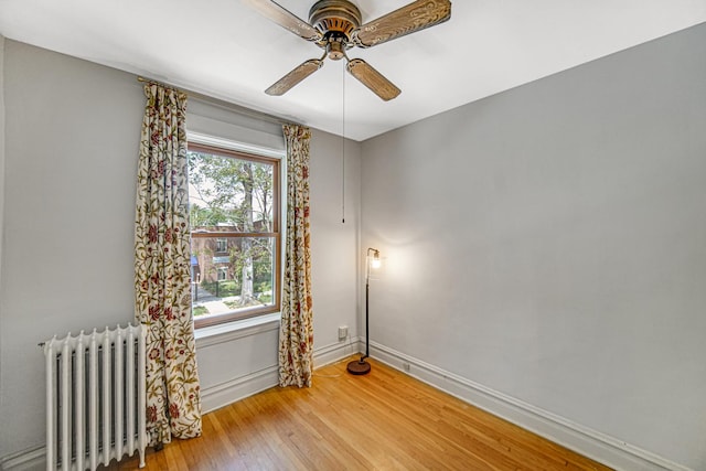 1044 S E Ave, Oak Park, IL 60304 - unfurnished room with radiator, a ceiling fan, light wood-style floors, and baseboards