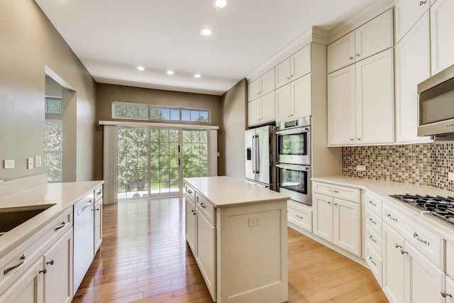 2334 Glen Eagles Ln, Riverwoods, IL 60015 - kitchen featuring appliances with stainless steel finishes, light wood-type flooring, decorative backsplash, recessed lighting, and a center island