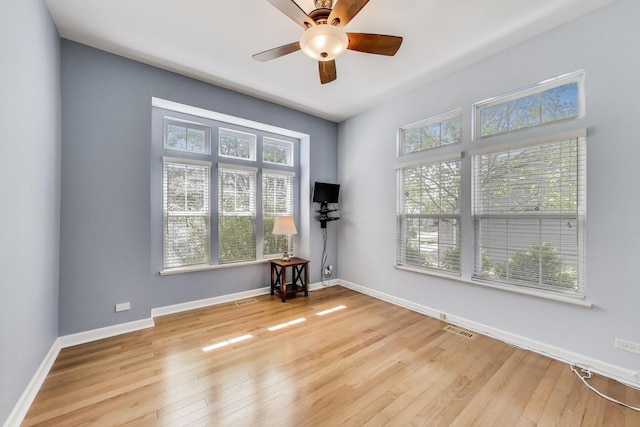 2334 Glen Eagles Ln, Riverwoods, IL 60015 - empty room featuring healthy amount of natural light, a ceiling fan, wood-type flooring, and baseboards