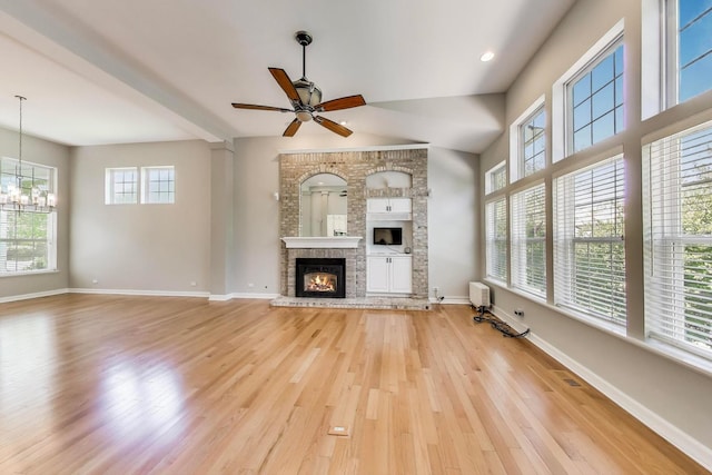 2334 Glen Eagles Ln, Riverwoods, IL 60015 - unfurnished living room featuring light wood finished floors, a chandelier, ceiling fan, a fireplace, and baseboards