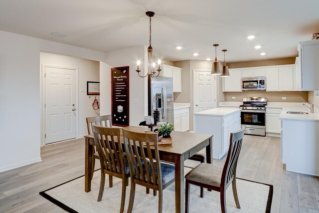 740 Cloverleaf Dr, Marengo, IL 60152 - dining area with light wood-type flooring, recessed lighting, a chandelier, and baseboards