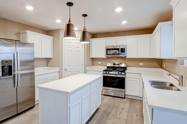 740 Cloverleaf Dr, Marengo, IL 60152 - kitchen featuring appliances with stainless steel finishes, a sink, light wood-type flooring, white cabinets, and recessed lighting