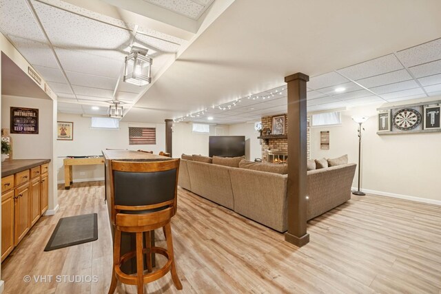 238 1st St, Cary, IL 60013 - dining room featuring a paneled ceiling, baseboards, and light wood-type flooring