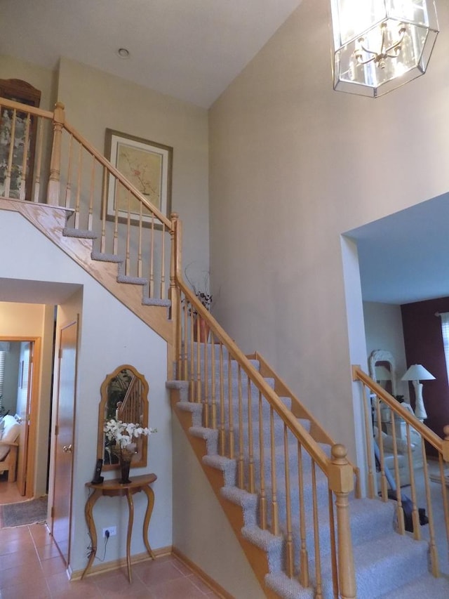 5355 Fox Path Ln, Hoffman Estates, IL 60192 - stairway featuring tile patterned flooring, a high ceiling, and a chandelier