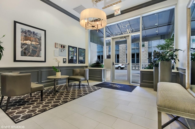 community lobby with ornamental molding, wainscoting, and a decorative wall