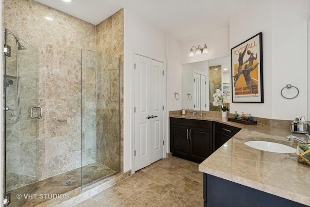 bathroom with a shower stall and vanity
