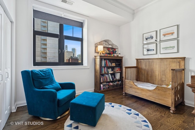 sitting room featuring crown molding, wood finished floors, and baseboards