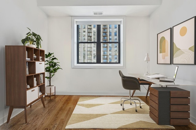 office space with wood finished floors and baseboards