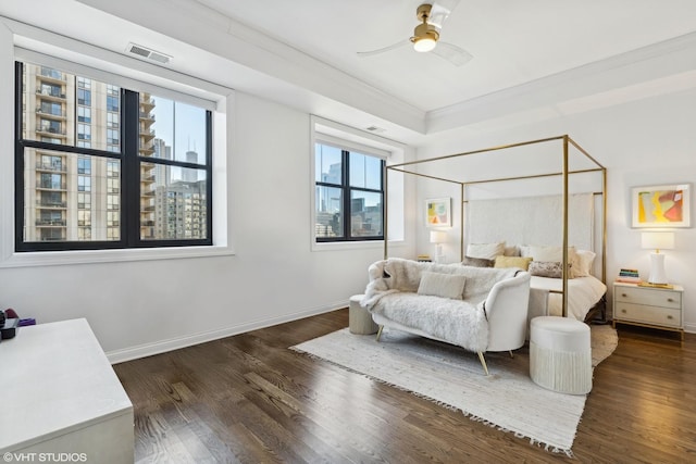 bedroom featuring dark wood-style flooring, crown molding, baseboards, and a ceiling fan