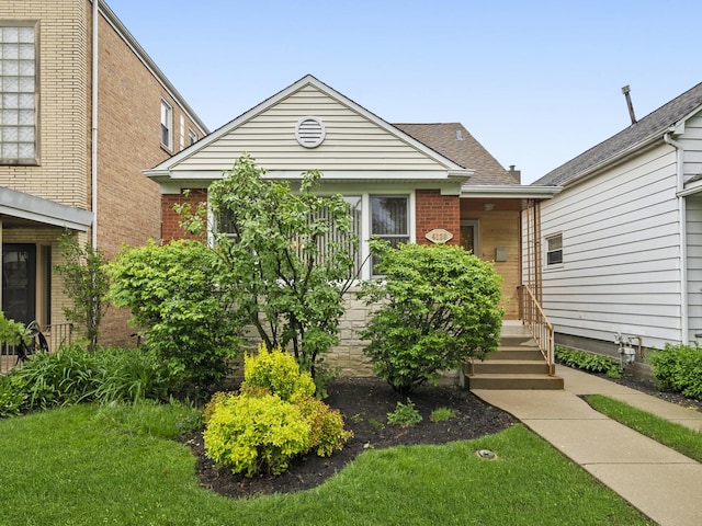 4129 N Mcvicker Ave, Chicago, IL 60634 - view of front of home featuring brick siding and a shingled roof