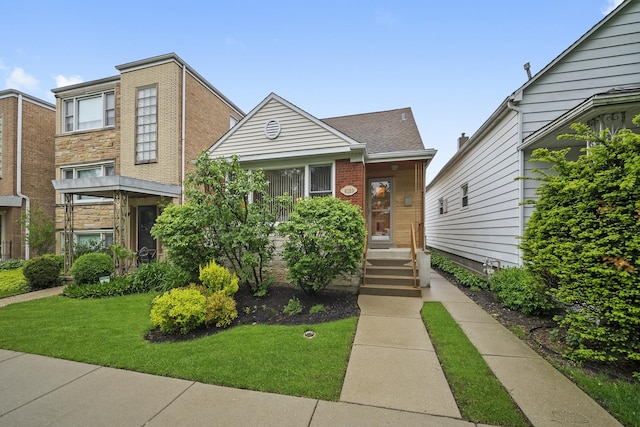 4129 N Mcvicker Ave, Chicago, IL 60634 - view of front of home featuring a front yard and brick siding