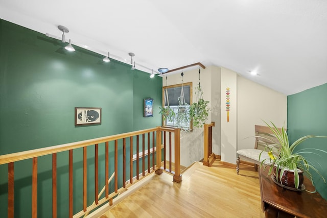 4129 N Mcvicker Ave, Chicago, IL 60634 - hall featuring an upstairs landing, wood finished floors, rail lighting, baseboards, and vaulted ceiling