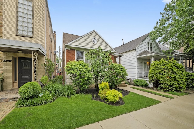 4129 N Mcvicker Ave, Chicago, IL 60634 - view of front of property featuring brick siding, a front lawn, and covered porch