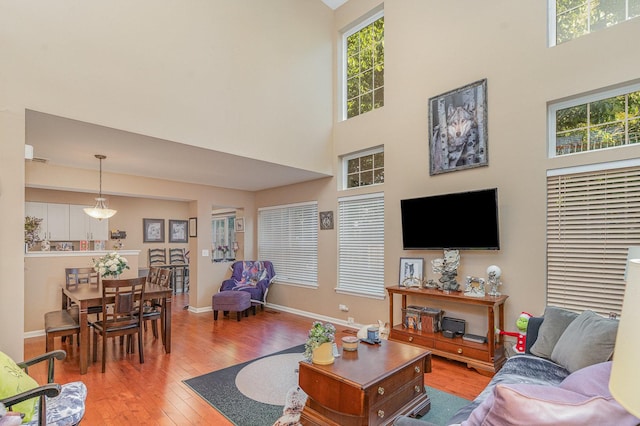 1966 Waverly Way, Montgomery, IL 60538 - living room featuring a towering ceiling, light wood-style flooring, and baseboards